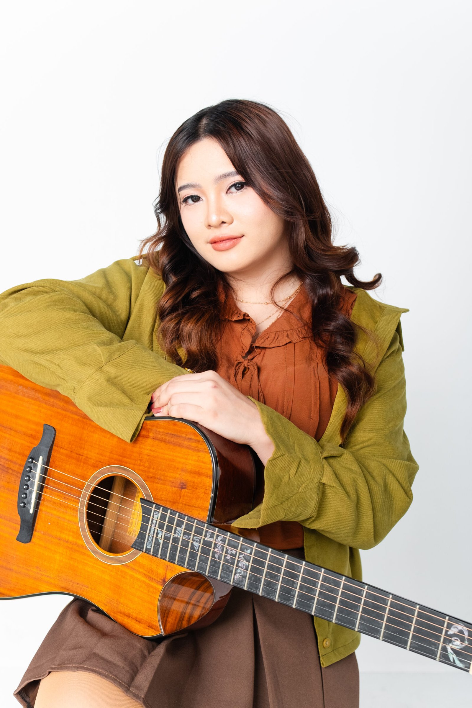 Kyla Jean, acoustic singer and guitarist from Davao City, holding her acoustic guitar