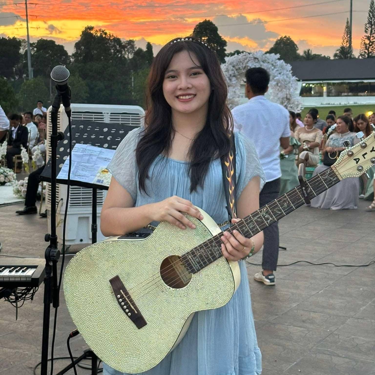 Kyla Jean at an outdoor wedding ceremony at sunset